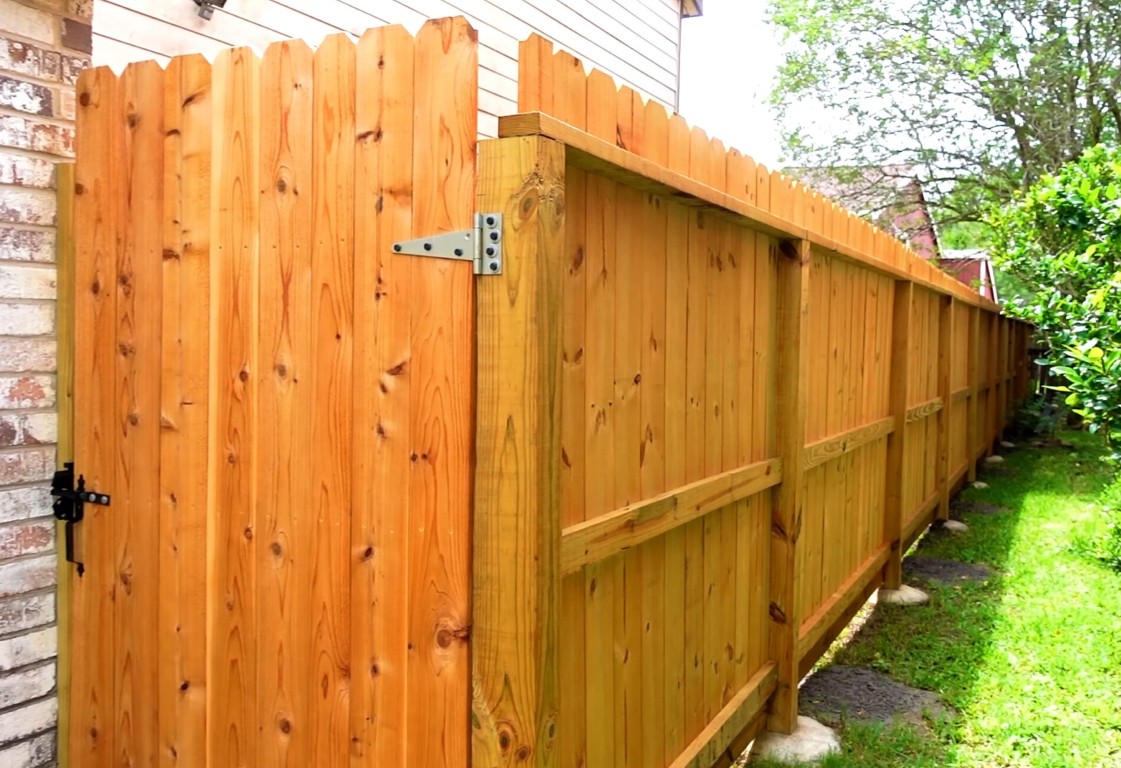 Secure wooden fence gate with privacy features